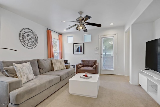 living area featuring recessed lighting, ceiling fan, light colored carpet, and a wealth of natural light