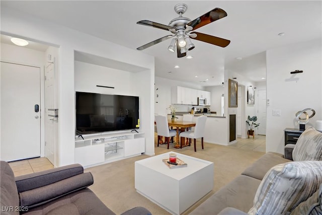 living area featuring ceiling fan, light carpet, and recessed lighting