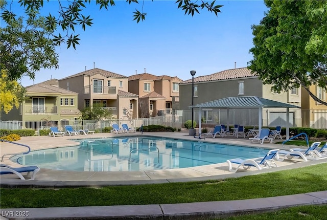 community pool with fence, a patio, a gazebo, and a residential view