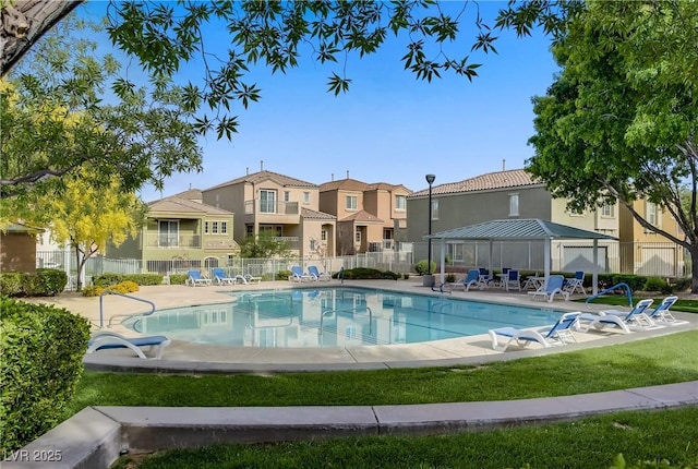 community pool featuring a gazebo, fence, a residential view, and a patio