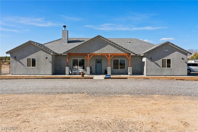 3880 Rudek St, Pahrump, NV 89061 - back of house featuring a chimney and stucco siding