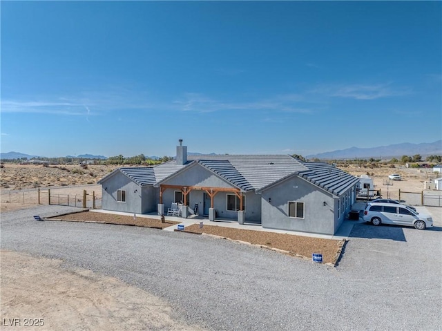3880 Rudek St, Pahrump, NV 89061 - ranch-style house featuring a chimney, a mountain view, stucco siding, and a tile roof