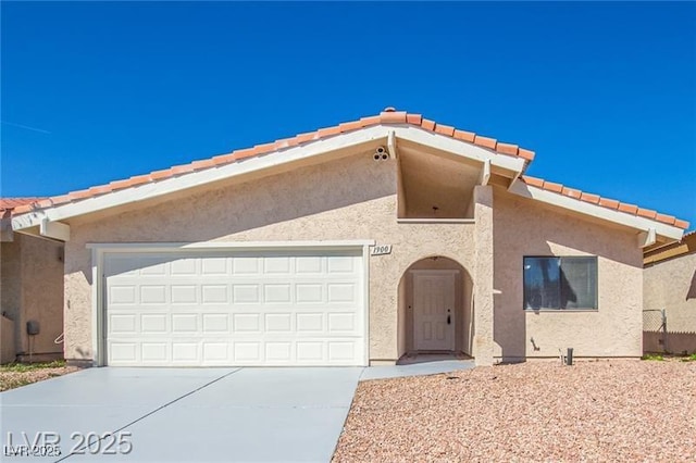 1900 Cameron St, Las Vegas, NV 89102 - view of front of house with stucco siding, driveway, a tiled roof, and a garage