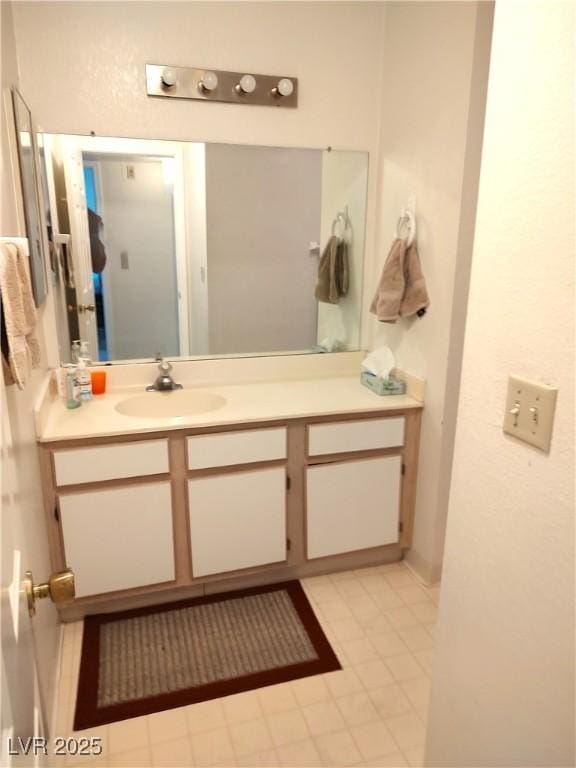 bathroom featuring tile patterned flooring and vanity