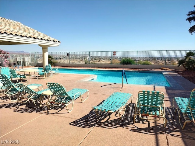 pool featuring fence and a patio area