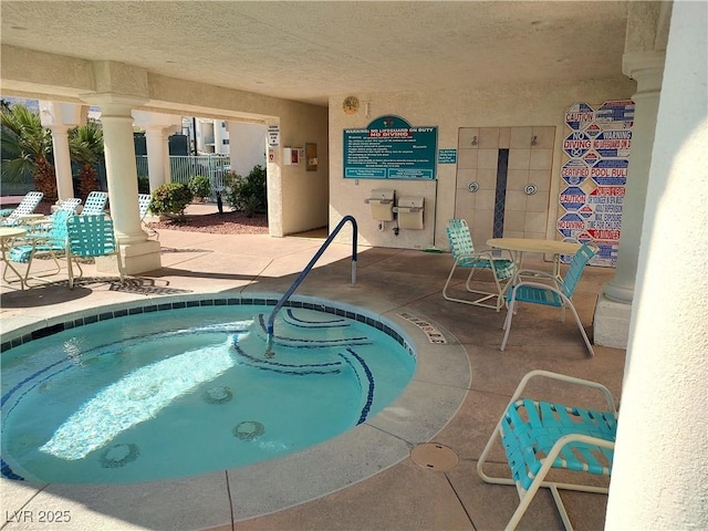 view of swimming pool with a patio area and a hot tub