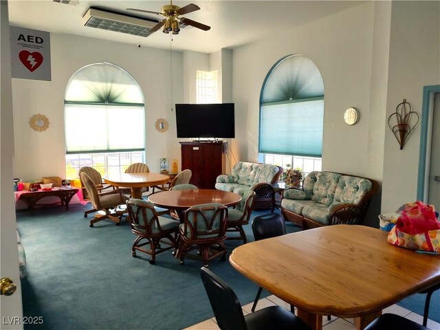 carpeted dining room featuring a ceiling fan