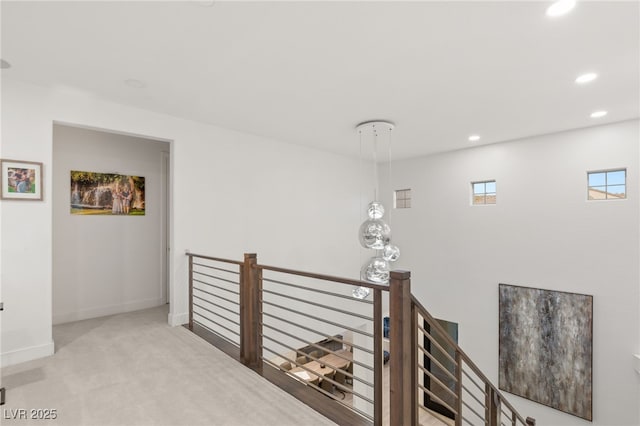 corridor with baseboards, carpet flooring, recessed lighting, and an upstairs landing