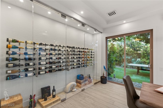 wine cellar with wood finished floors, visible vents, and recessed lighting