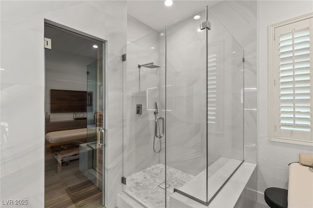 full bathroom with recessed lighting and a stall shower