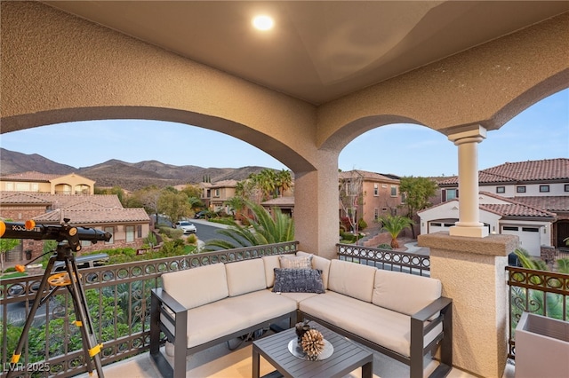 view of patio / terrace with a residential view, an outdoor living space, a balcony, and a mountain view