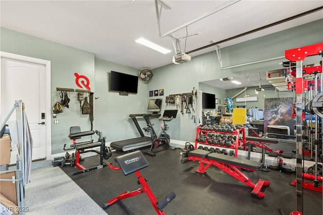 gym featuring a garage and baseboards