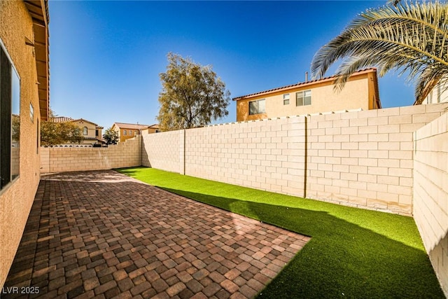 view of yard with a patio area and a fenced backyard