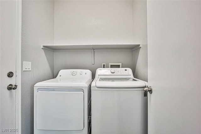 clothes washing area featuring washer and dryer and laundry area