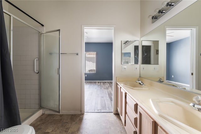 1838 N Jones Blvd, Las Vegas, NV 89108 - full bathroom with a tile shower, double vanity, and baseboards