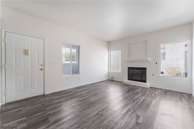 1838 N Jones Blvd, Las Vegas, NV 89108 - unfurnished living room featuring dark wood-style floors, a glass covered fireplace, and baseboards
