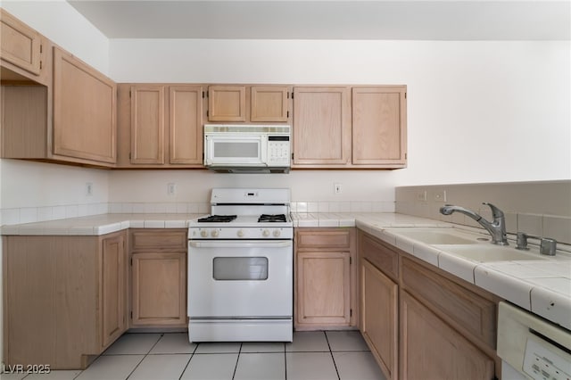 1838 N Jones Blvd, Las Vegas, NV 89108 - kitchen with white appliances, a sink, light tile patterned floors, and light brown cabinets