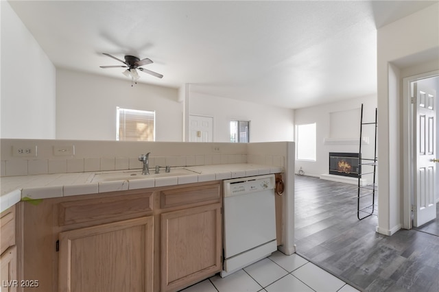 1838 N Jones Blvd, Las Vegas, NV 89108 - kitchen featuring white dishwasher, open floor plan, a sink, ceiling fan, and a glass covered fireplace