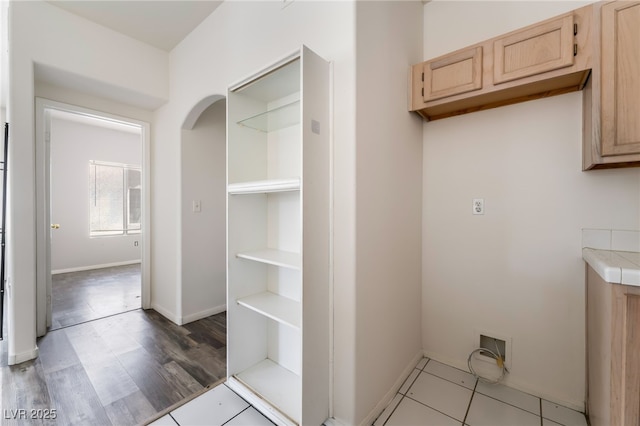 1838 N Jones Blvd, Las Vegas, NV 89108 - laundry room with arched walkways, light wood-style flooring, and baseboards