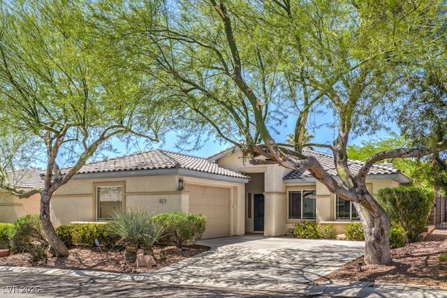 2647 Ivoryhill St, Las Vegas, NV 89135 - mediterranean / spanish-style house featuring a tile roof, an attached garage, stucco siding, and driveway