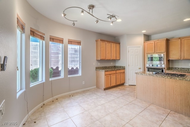 2647 Ivoryhill St, Las Vegas, NV 89135 - kitchen featuring stainless steel appliances, dark stone counters, baseboards, and light tile patterned floors
