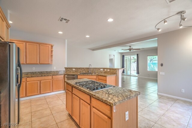2647 Ivoryhill St, Las Vegas, NV 89135 - kitchen with open shelves, light tile patterned floors, a sink, a peninsula, and appliances with stainless steel finishes