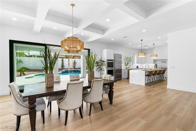 dining space featuring light wood finished floors, recessed lighting, and coffered ceiling