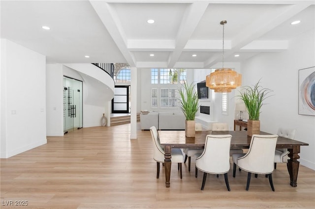 dining room featuring light wood finished floors, recessed lighting, a notable chandelier, coffered ceiling, and beamed ceiling