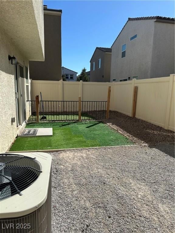 view of yard featuring a fenced backyard, central AC unit, and a patio area