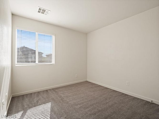 carpeted spare room with baseboards and visible vents