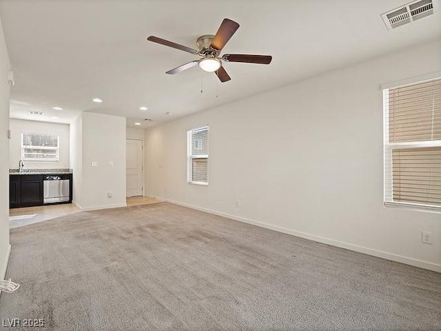empty room with light colored carpet, visible vents, baseboards, recessed lighting, and a ceiling fan