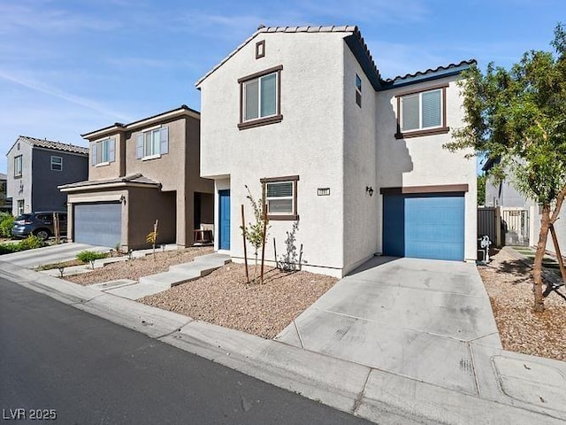 view of front facade featuring stucco siding, driveway, and an attached garage