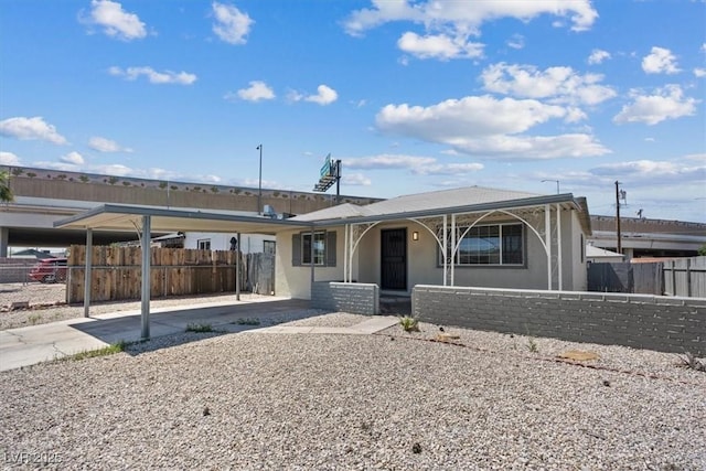 429 N 10th St, Las Vegas, NV 89101 - view of front of house featuring stucco siding, a carport, and a porch