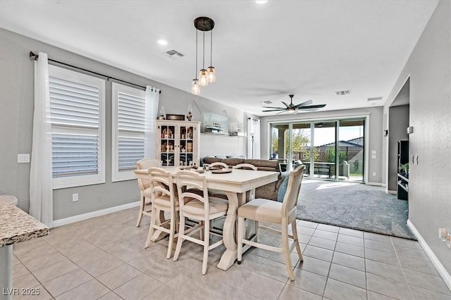 dining area featuring ceiling fan, light tile patterned flooring, and visible vents