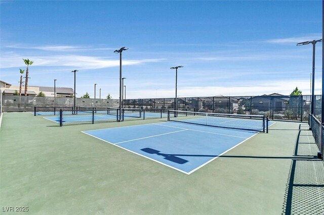 view of sport court with fence