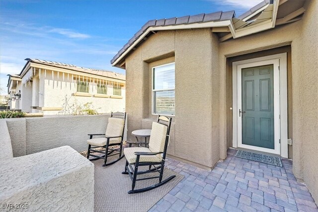 property entrance with stucco siding