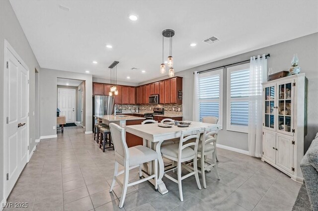 dining space with light tile patterned flooring, visible vents, baseboards, and recessed lighting