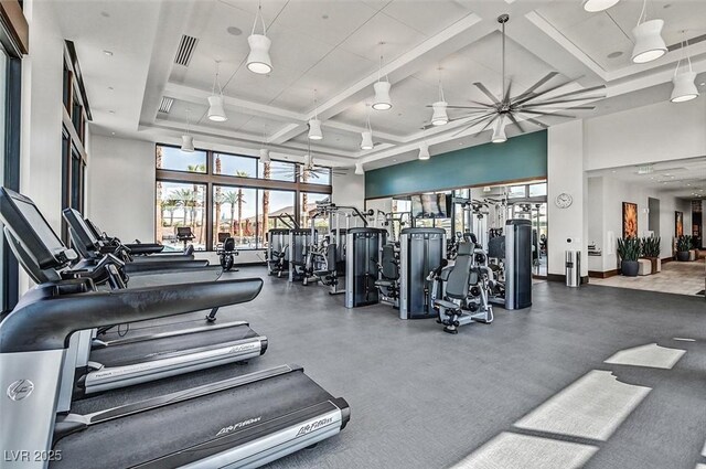workout area featuring water heater, a high ceiling, recessed lighting, and coffered ceiling