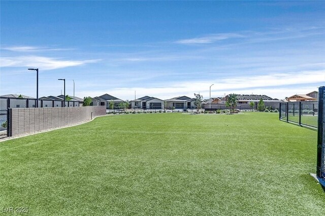 view of yard featuring fence and a residential view