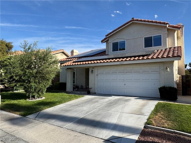 2807 Camelback Ln, Henderson, NV 89074 - mediterranean / spanish-style house with a front yard, stucco siding, a tile roof, and roof mounted solar panels