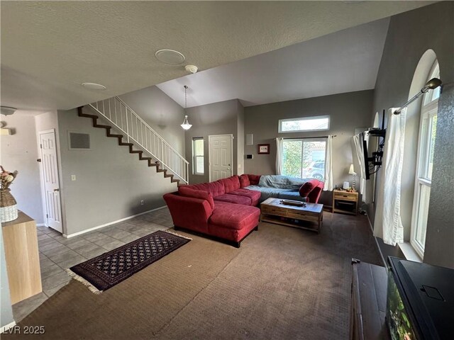 2807 Camelback Ln, Henderson, NV 89074 - living area with lofted ceiling, a textured ceiling, dark tile patterned floors, visible vents, and stairway