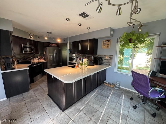 2807 Camelback Ln, Henderson, NV 89074 - kitchen with stainless steel microwave, a sink, visible vents, black range with electric cooktop, and fridge with ice dispenser