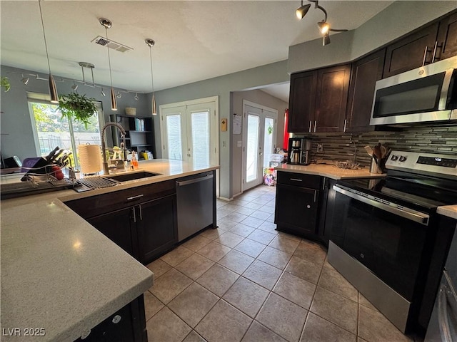 2807 Camelback Ln, Henderson, NV 89074 - kitchen with french doors, visible vents, a sink, stainless steel appliances, and tasteful backsplash