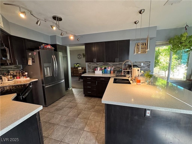 2807 Camelback Ln, Henderson, NV 89074 - kitchen with light countertops, appliances with stainless steel finishes, light tile patterned floors, and a sink