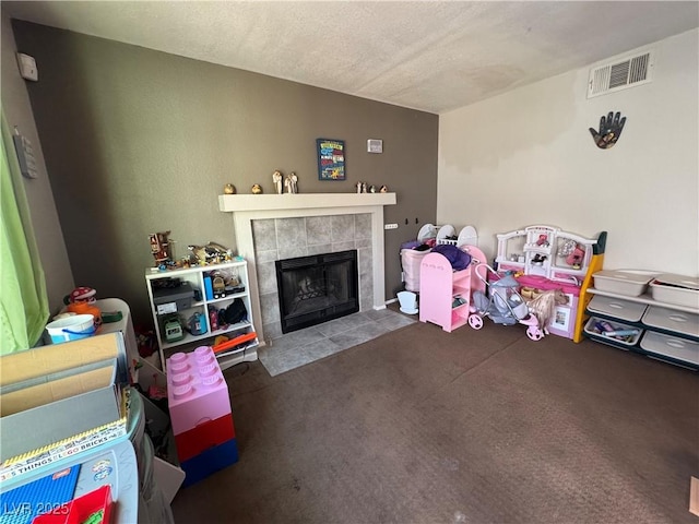 2807 Camelback Ln, Henderson, NV 89074 - game room with a fireplace, a textured ceiling, carpet, and visible vents