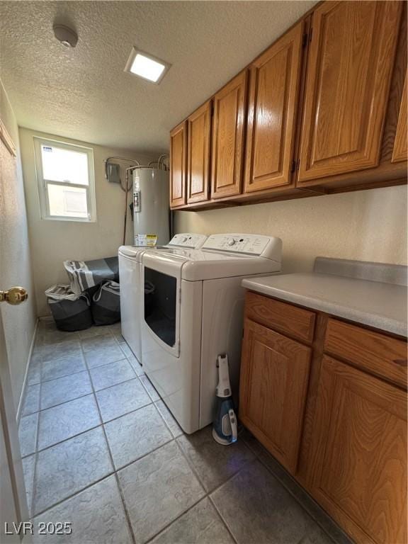 2807 Camelback Ln, Henderson, NV 89074 - laundry area with independent washer and dryer, a textured ceiling, light tile patterned floors, gas water heater, and cabinet space