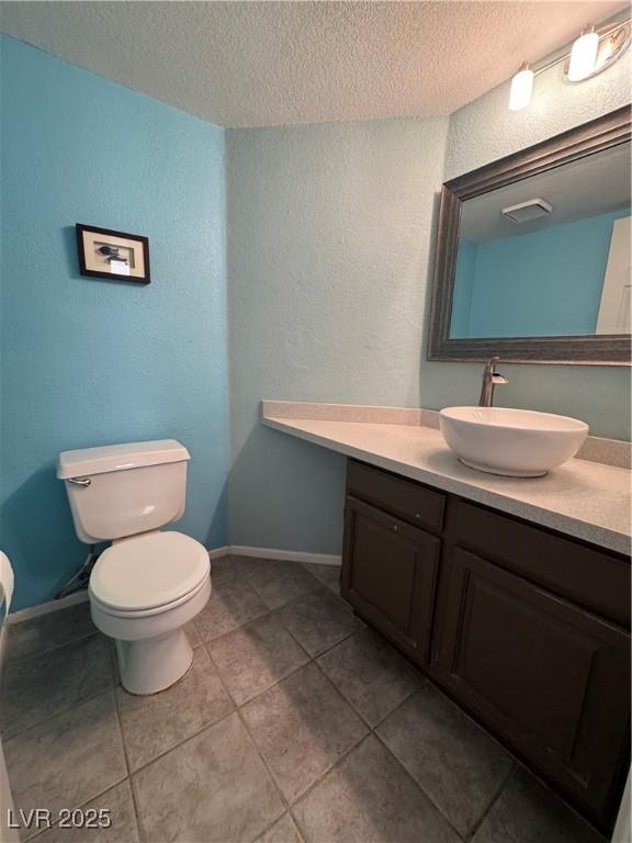 2807 Camelback Ln, Henderson, NV 89074 - bathroom with a textured ceiling, toilet, and tile patterned floors