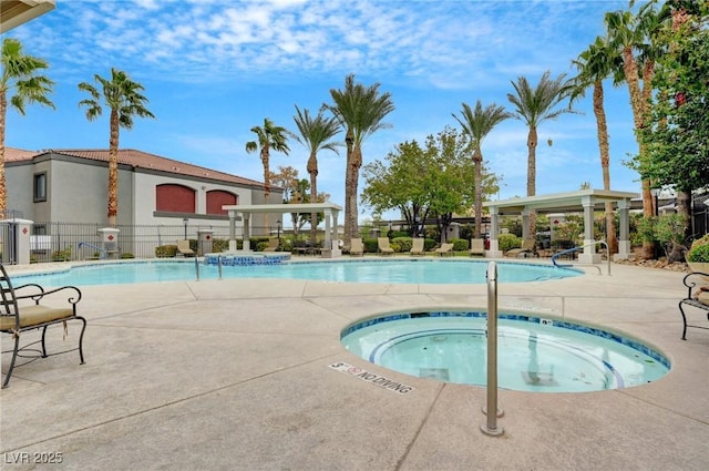 community pool with fence, a community hot tub, and a patio