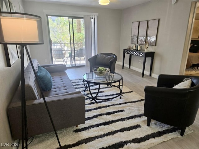 living room featuring wood finished floors and baseboards