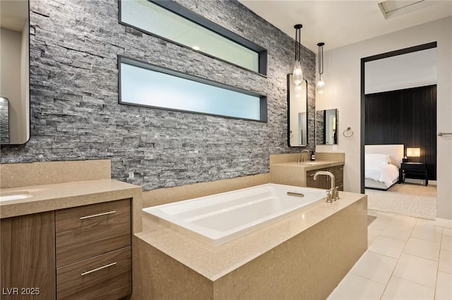 full bath with tile patterned floors, ensuite bathroom, a sink, a bath, and two vanities